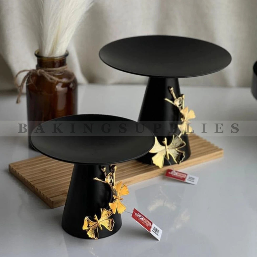 Black cake stands with gold butterfly decorations