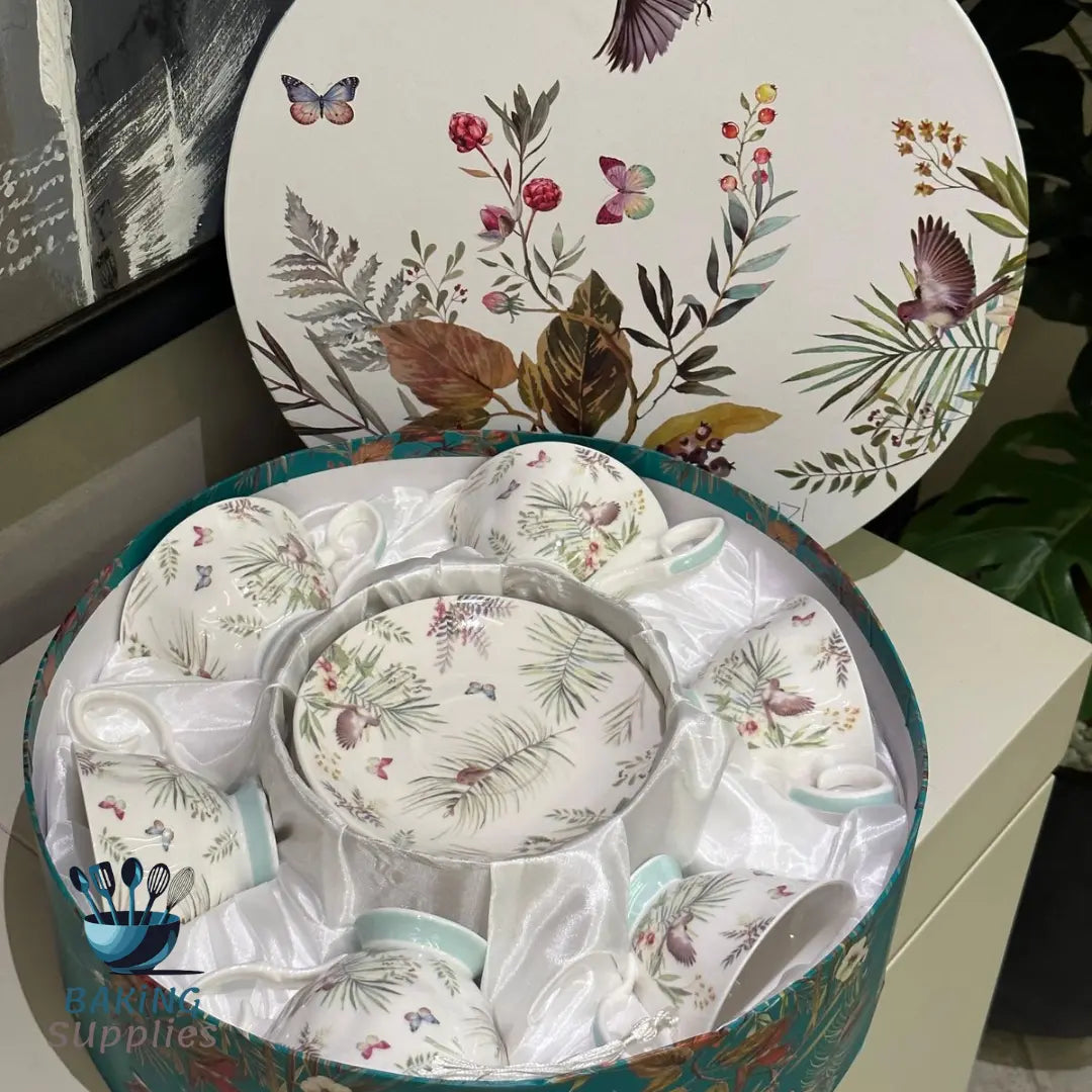 Set of ceramic dishes with nature-themed design in a decorative box.