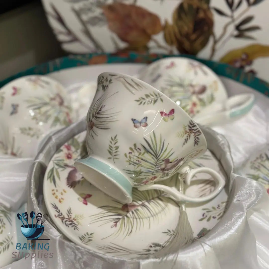 Set of ceramic tea cups and saucers with floral and butterfly design