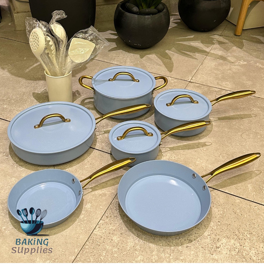 Set of light blue cookware with gold handles 