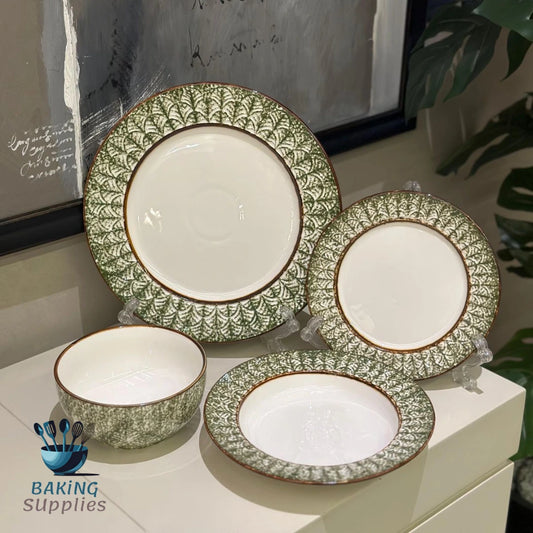 Set of ceramic plates with green and brown patterns.