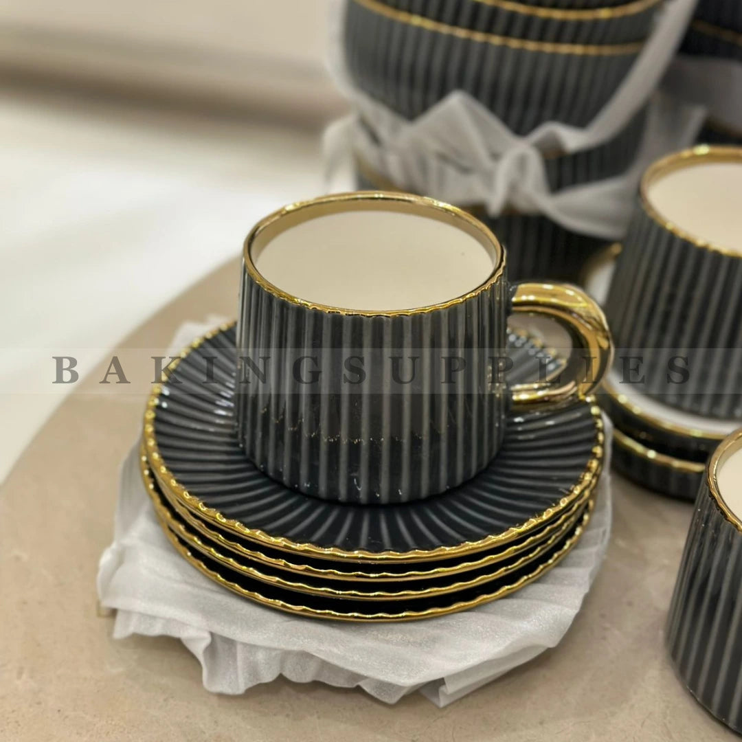 Set of black ribbed teacups with gold trim 