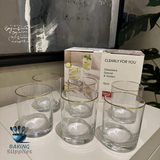 Set of clear glass with gold rims.