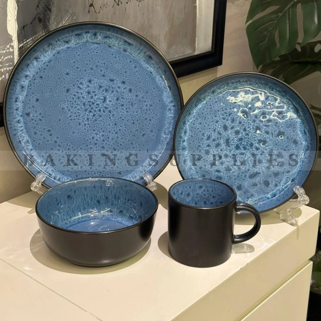 Set of blue ceramic plates, bowl, and mug