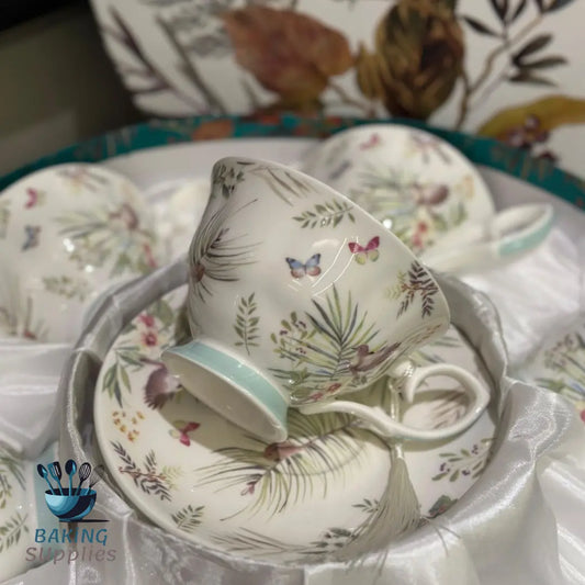 Set of ceramic tea cups and saucers with floral and butterfly design