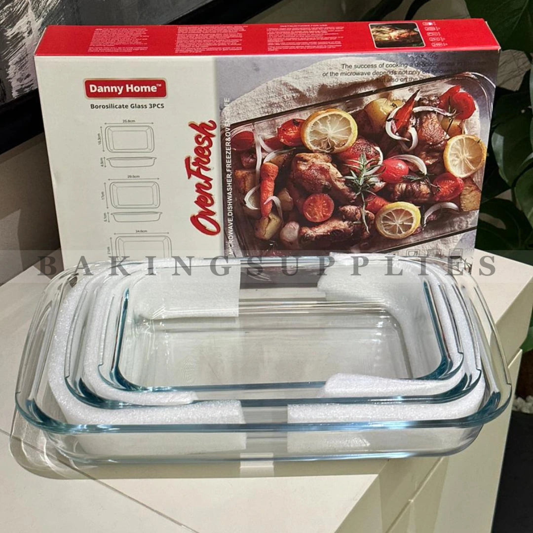 Glass baking dish with a red and white box featuring images of food on a light surface.