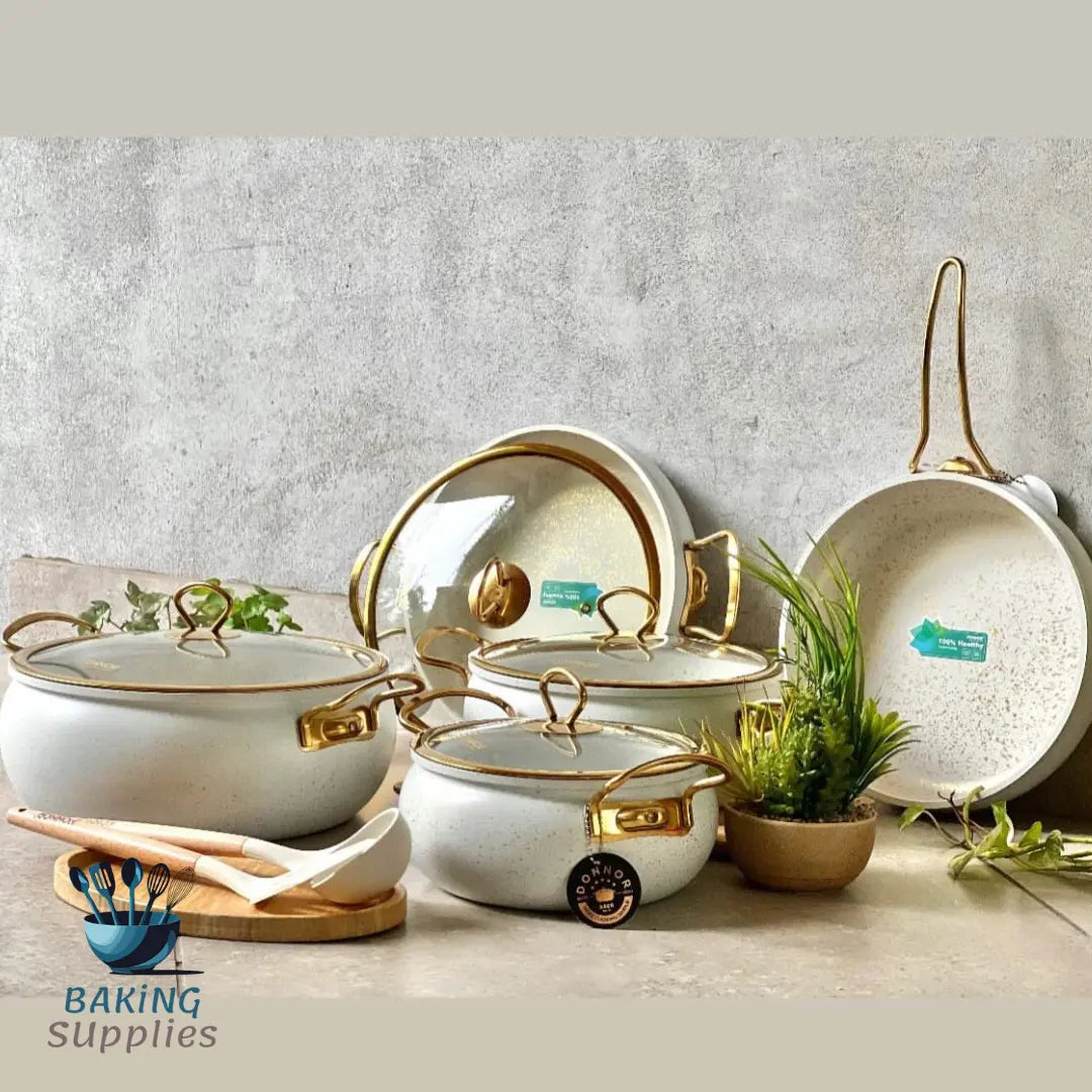 Set of white ceramic cookware with gold accents 