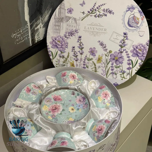 Floral teacup set with matching saucers in a decorative box, featuring lavender and floral designs.