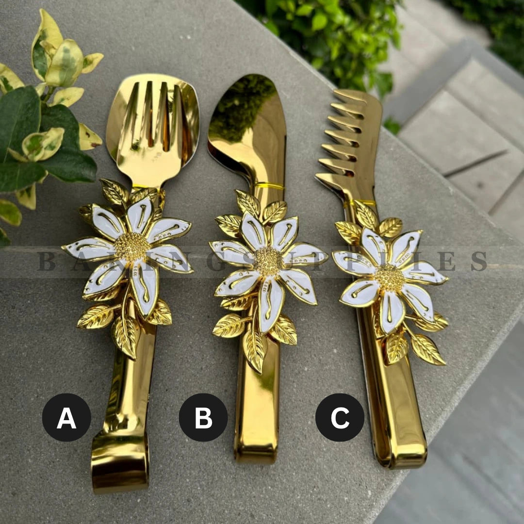 Set of gold cutlery with floral designs 