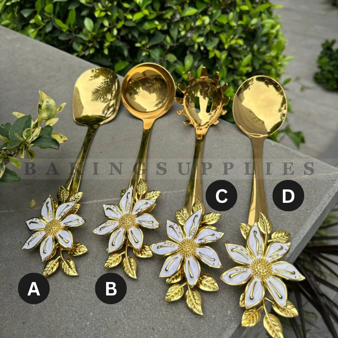 Set of four gold spoons with floral designs 