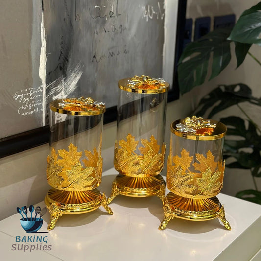 Three ornate gold candle holders